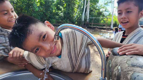Children drinking water, Native Community of Tayakome, Manu National Park